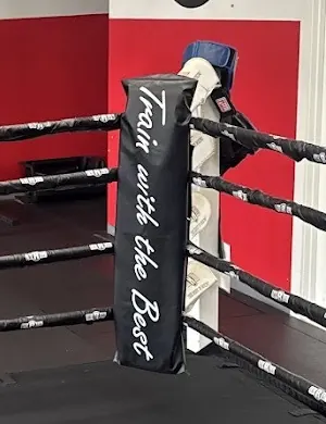 Corner pad of the boxing ring that says Train with the Best