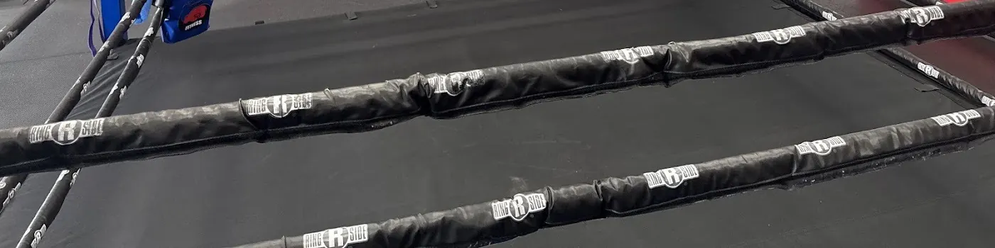 Close up of black boxing ring ropes with Ringside tags